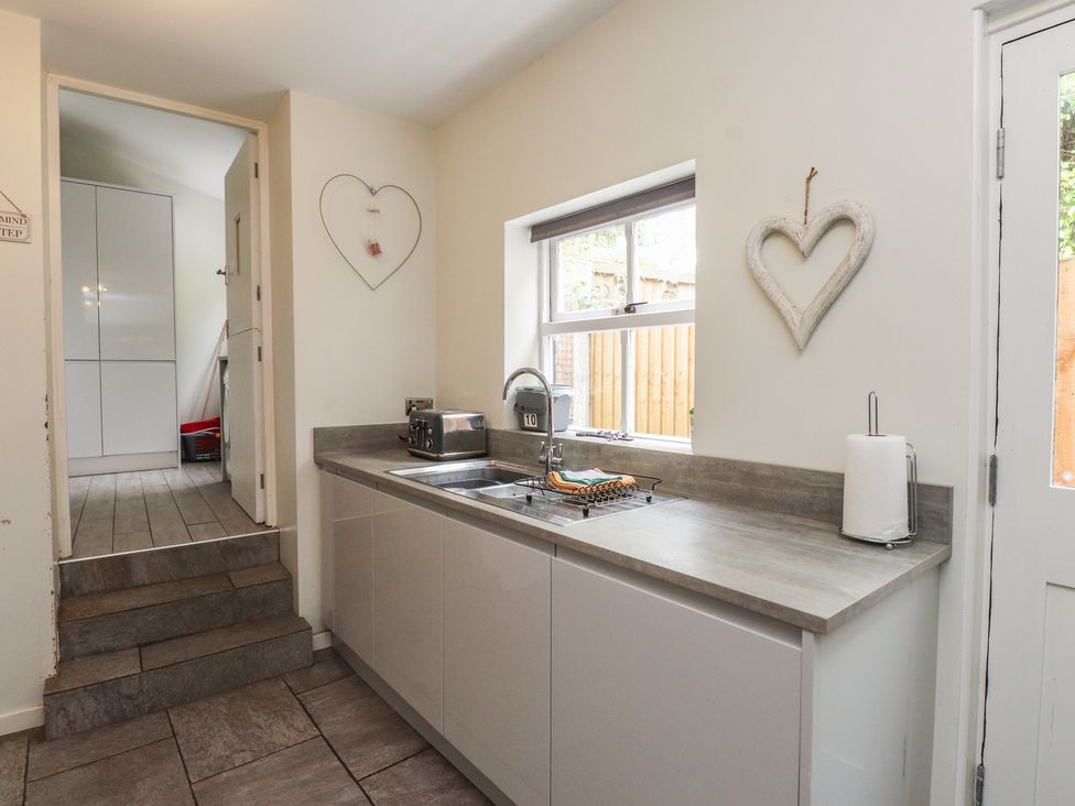 A kitchen with a sink and countertop at Conway Mart Cottage in Conwy