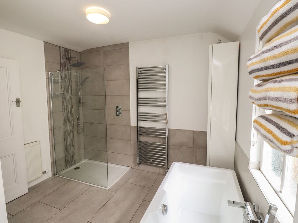 A bathroom with a shower and bathtub at Conway Mart Cottage in Conwy