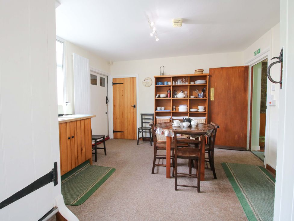 A kitchen with a table and chairs at Kwerky Cottage 