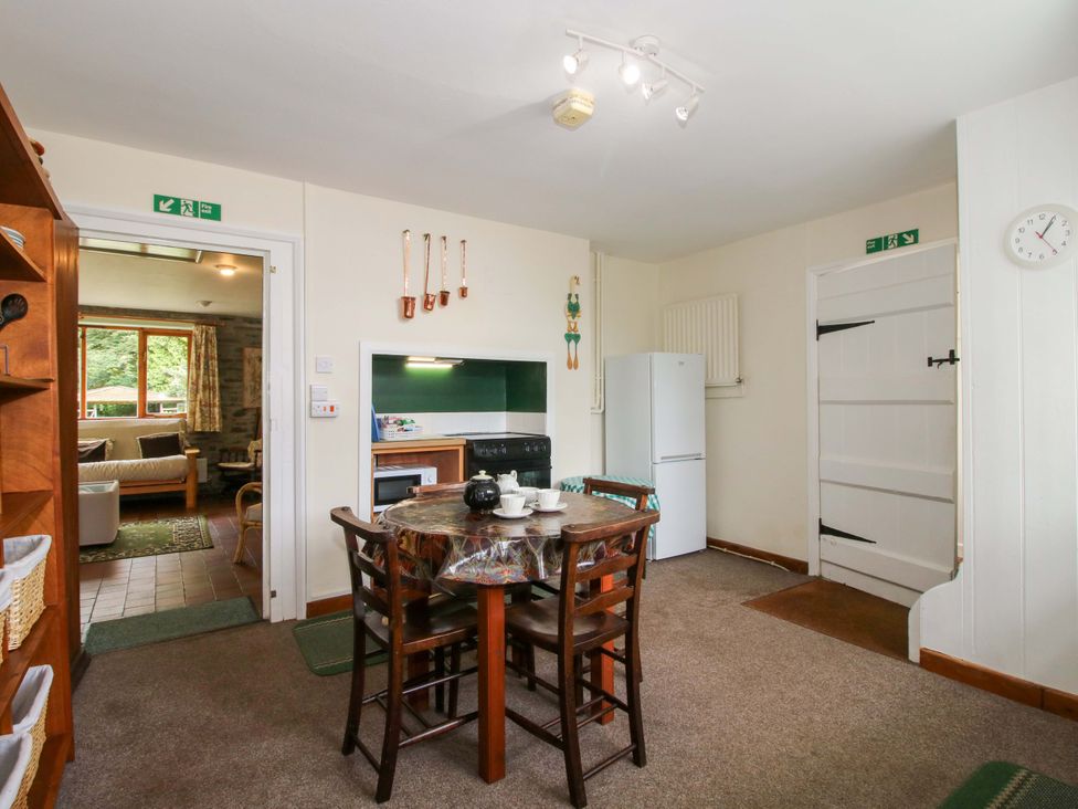 A kitchen with a dining table and chairs at Kwerky Cottage