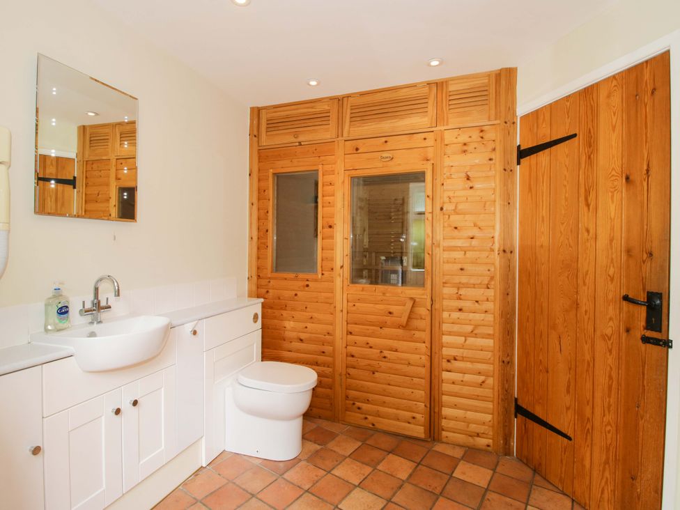A bathroom with a sink and toilet at Kwerky Cottage