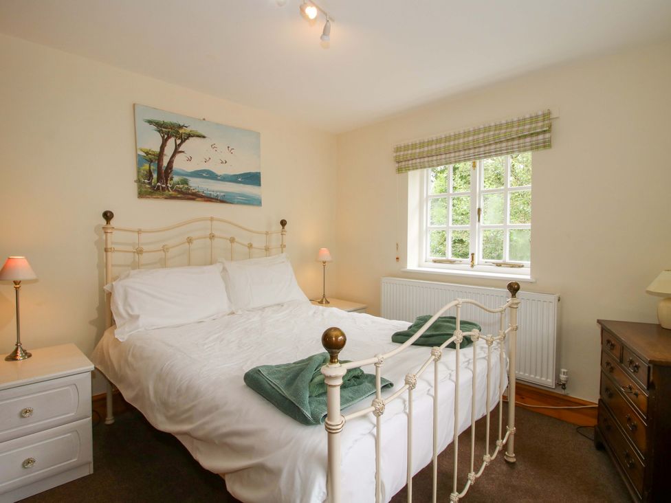 A bedroom with a bed and window at Kwerky Cottage