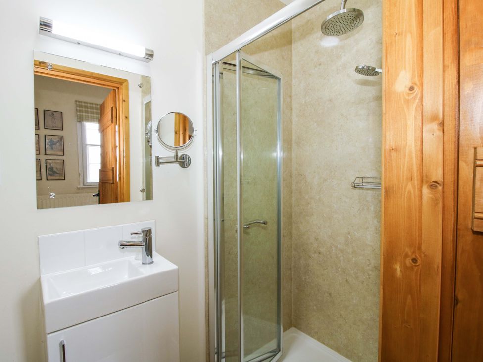 A bathroom with a shower and sink at Kwerky Cottage