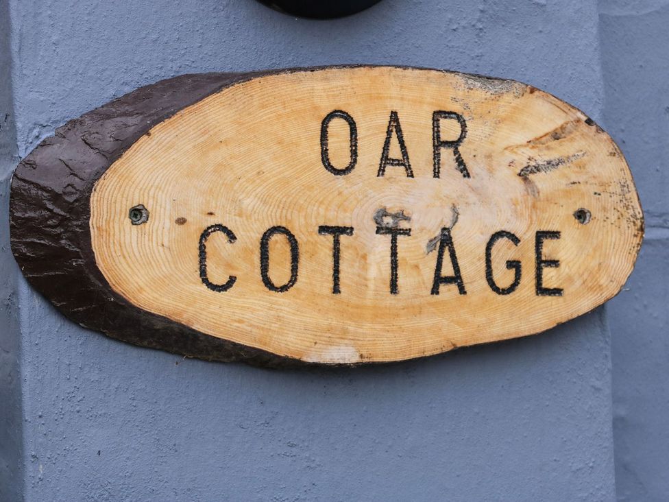 A wooden sign displaying the name Oar Cottage in Mablethorpe
