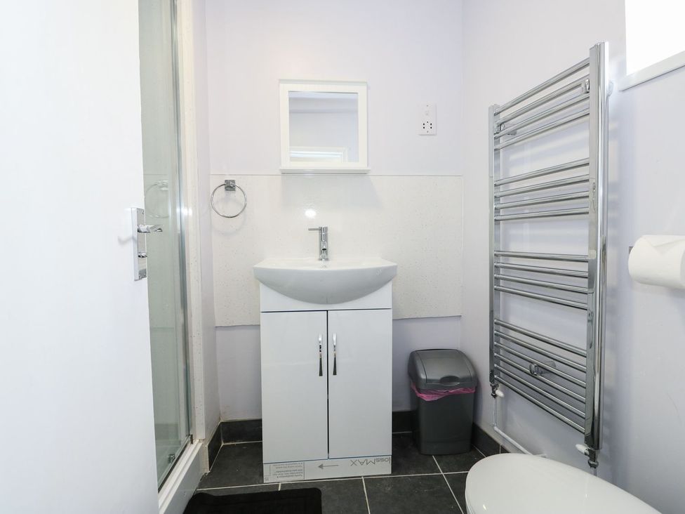 A bathroom with a sink and shower at Oar Cottage in Mablethorpe