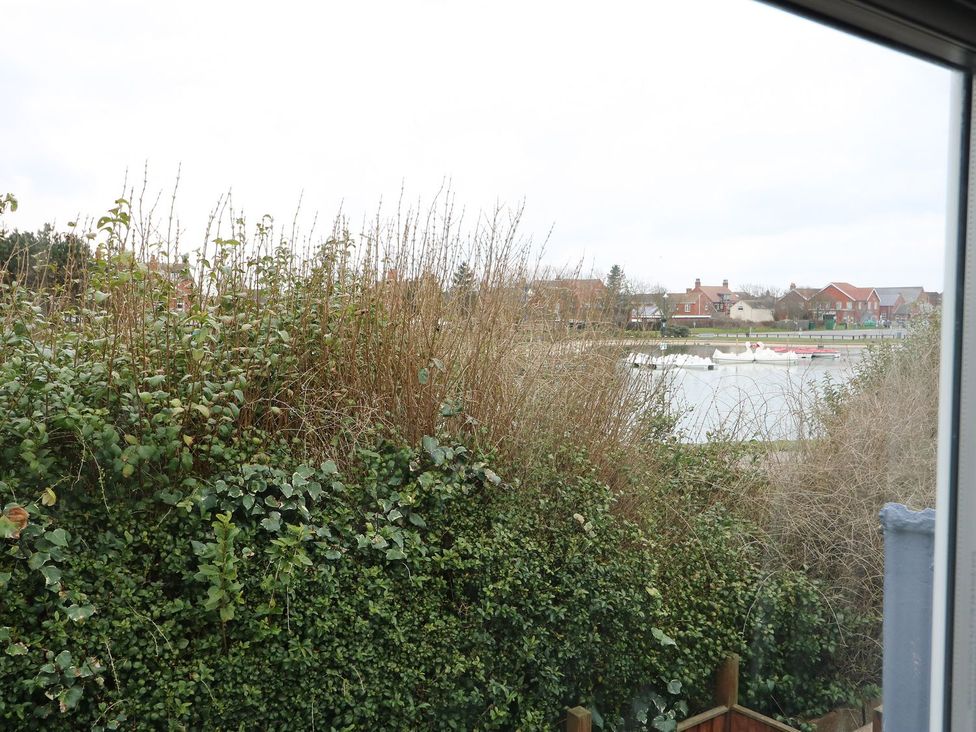 A view of water with houses and boats from Oar Cottage in Mablethorpe