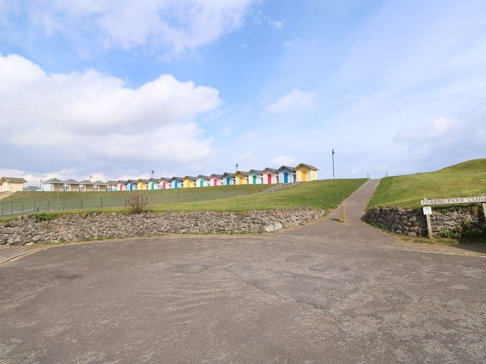 A row of colorful beach huts on a hill at Oar Cottage Mablethorpe