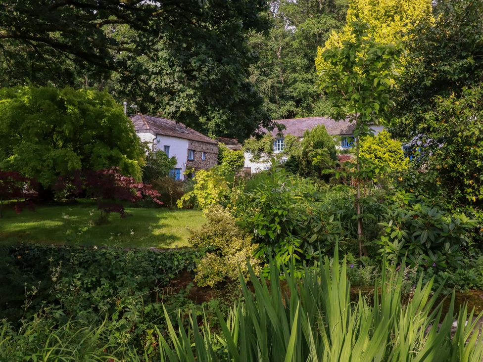 A garden with trees and plants at The Water Mill at Boyton Mill Launceston