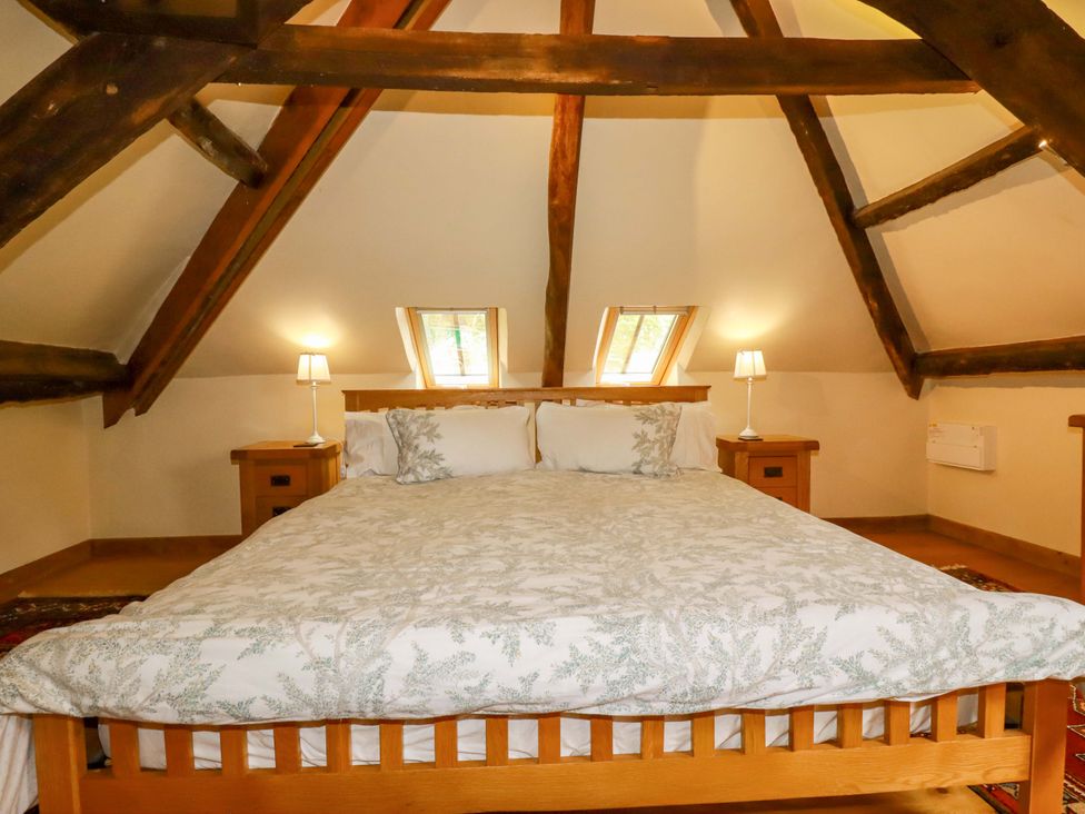 A bedroom with a bed and nightstands at The Water Mill at Boyton Mill Launceston