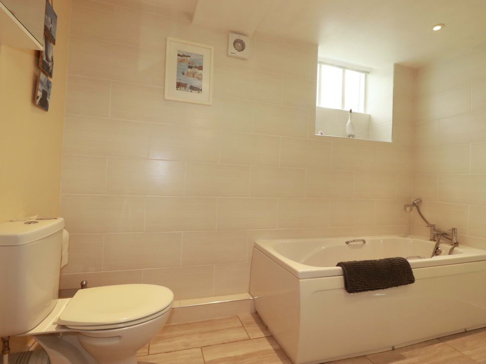 A bathroom with a bathtub and toilet at The Water Mill at Boyton Mill, Launceston