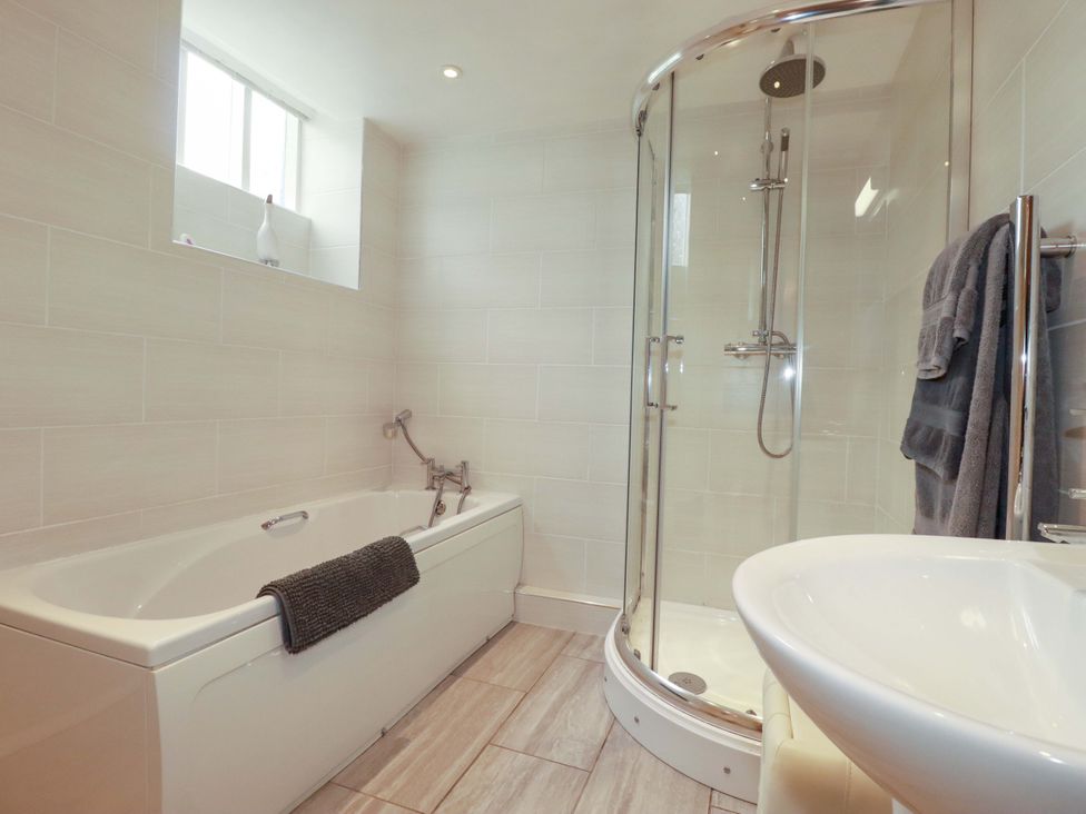 A bathroom with a bath tub and shower at The Water Mill at Boyton Mill in Launceston
