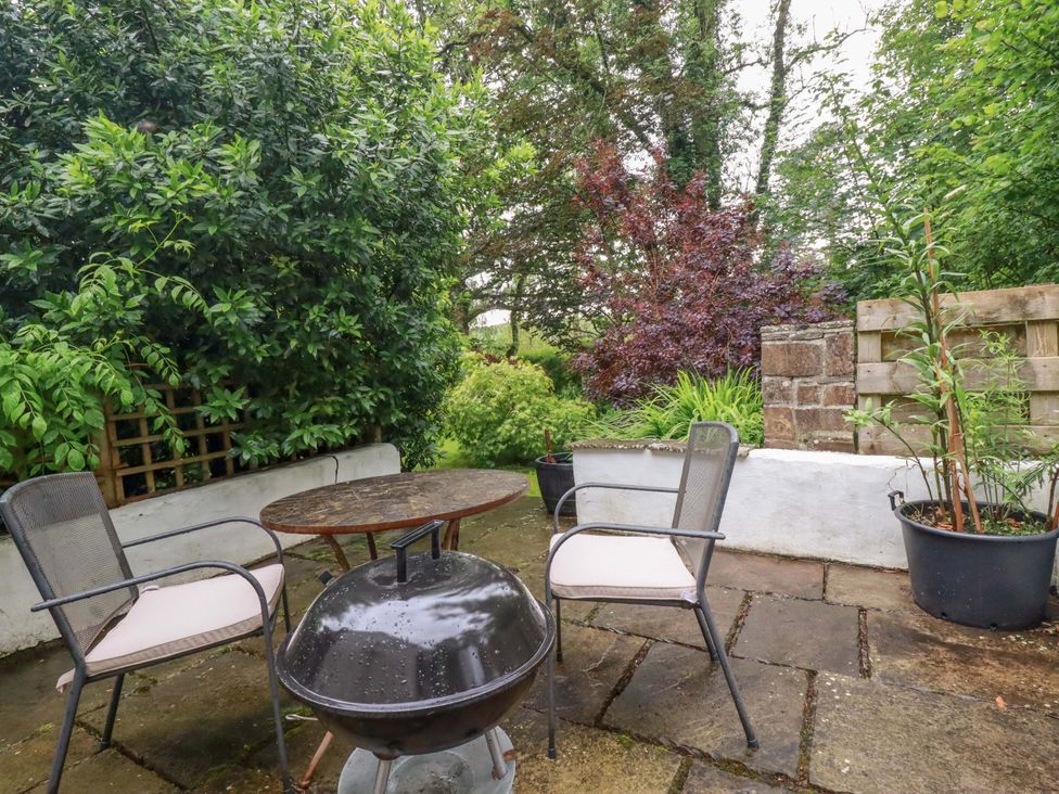 A garden area with a table and chairs at The Water Mill at Boyton Mill Launceston