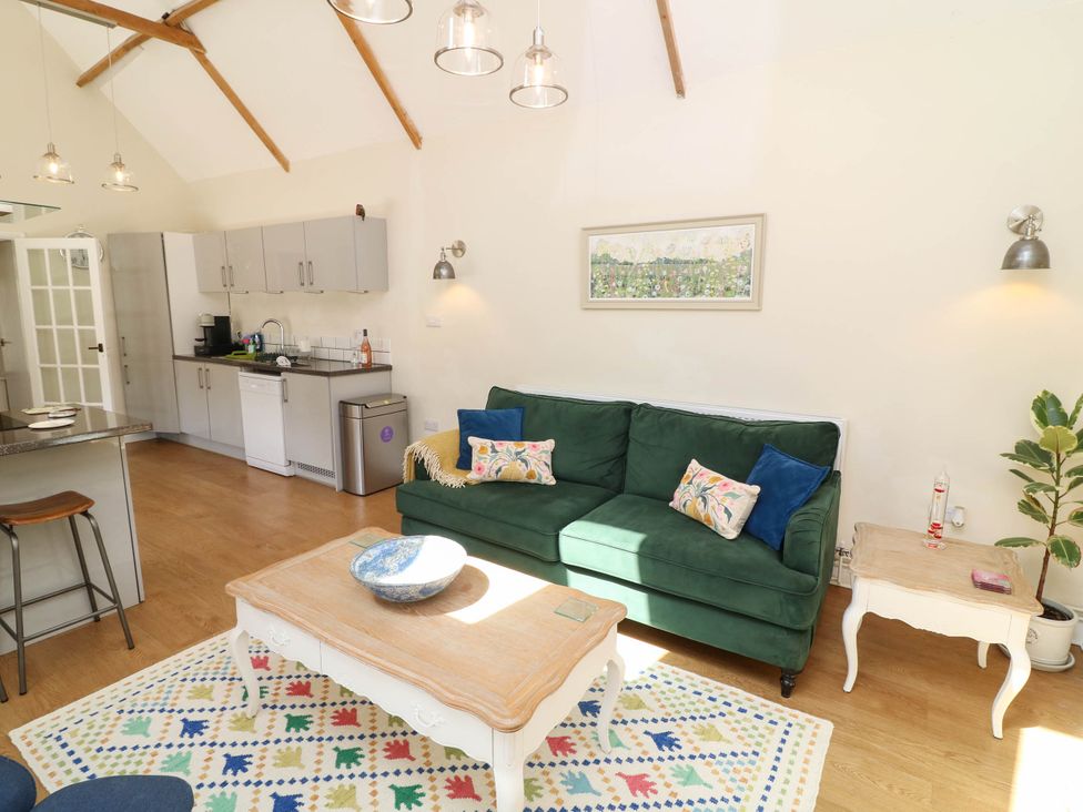 A living room with a sofa and coffee table at Wheelwrights Cottage in Corby Glen