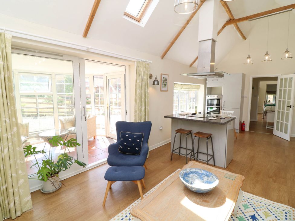 A kitchen with a dining area and seating at Wheelwrights Cottage in Corby Glen