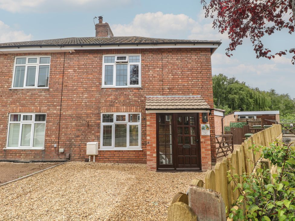 An exterior view of a brick house with windows and a door at The Kingfisher Falls in Melton Mowbray