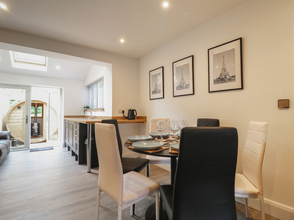 A dining room with a table set for a meal at The Kingfisher Falls in Melton Mowbray
