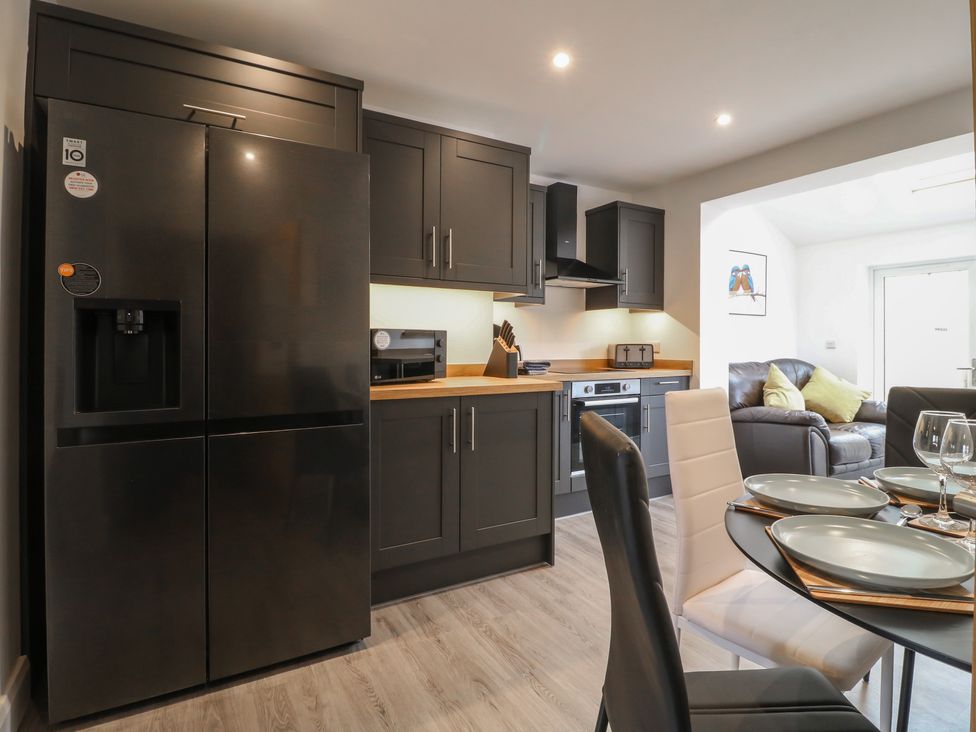 A kitchen with a refrigerator and microwave at The Kingfisher Falls in Melton Mowbray