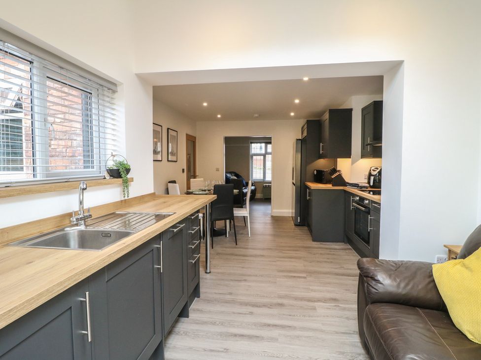 A kitchen with a sink and cabinets at The Kingfisher Falls in Melton Mowbray