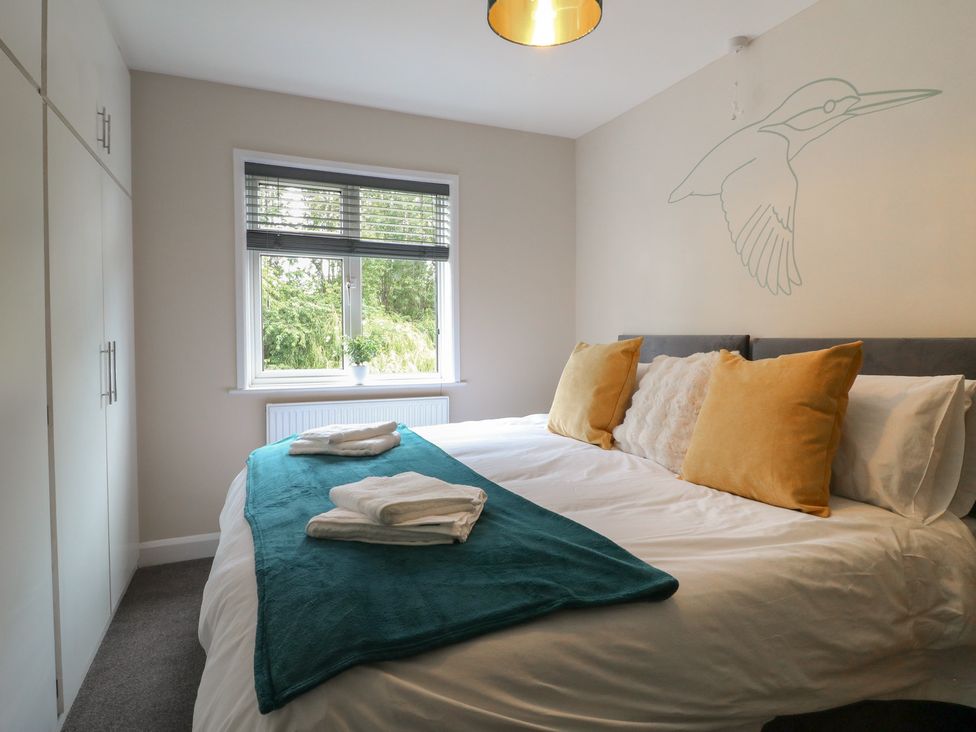 A bedroom with a bed and a window at The Kingfisher Falls in Melton Mowbray