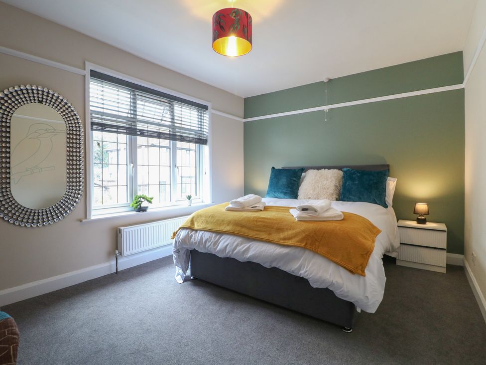 A bedroom with a bed and window at The Kingfisher Falls in Melton Mowbray