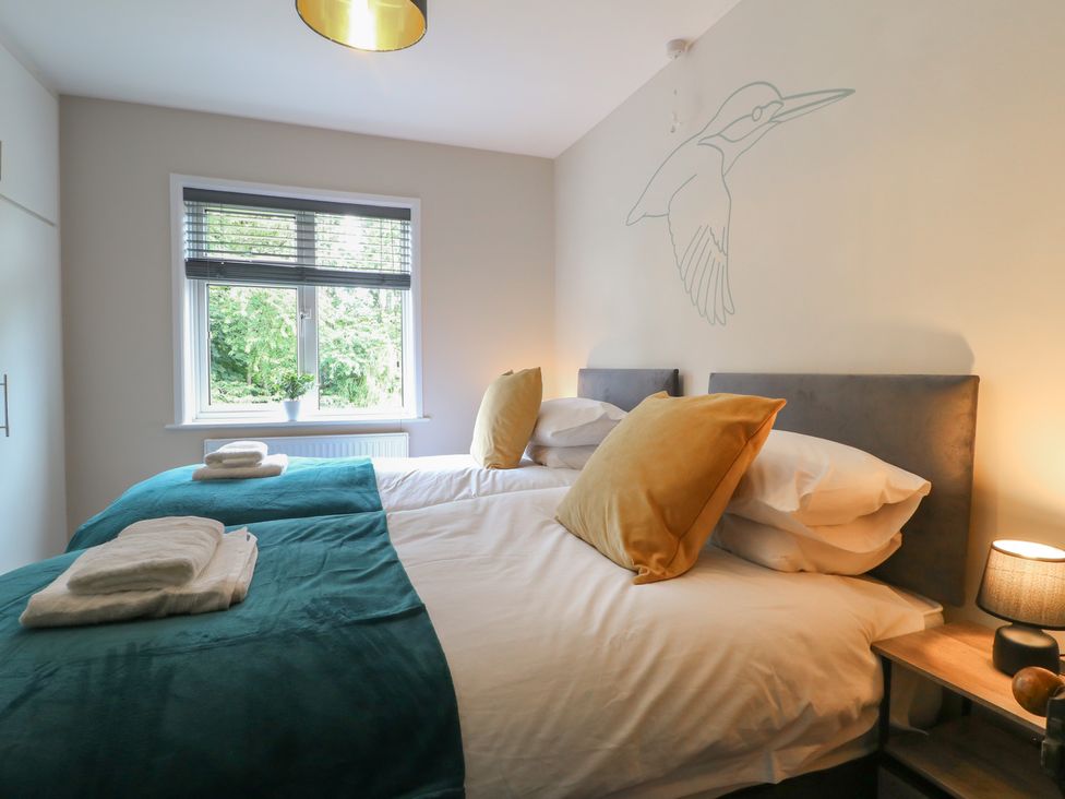 A bedroom with two beds and a window at The Kingfisher Falls in Melton Mowbray