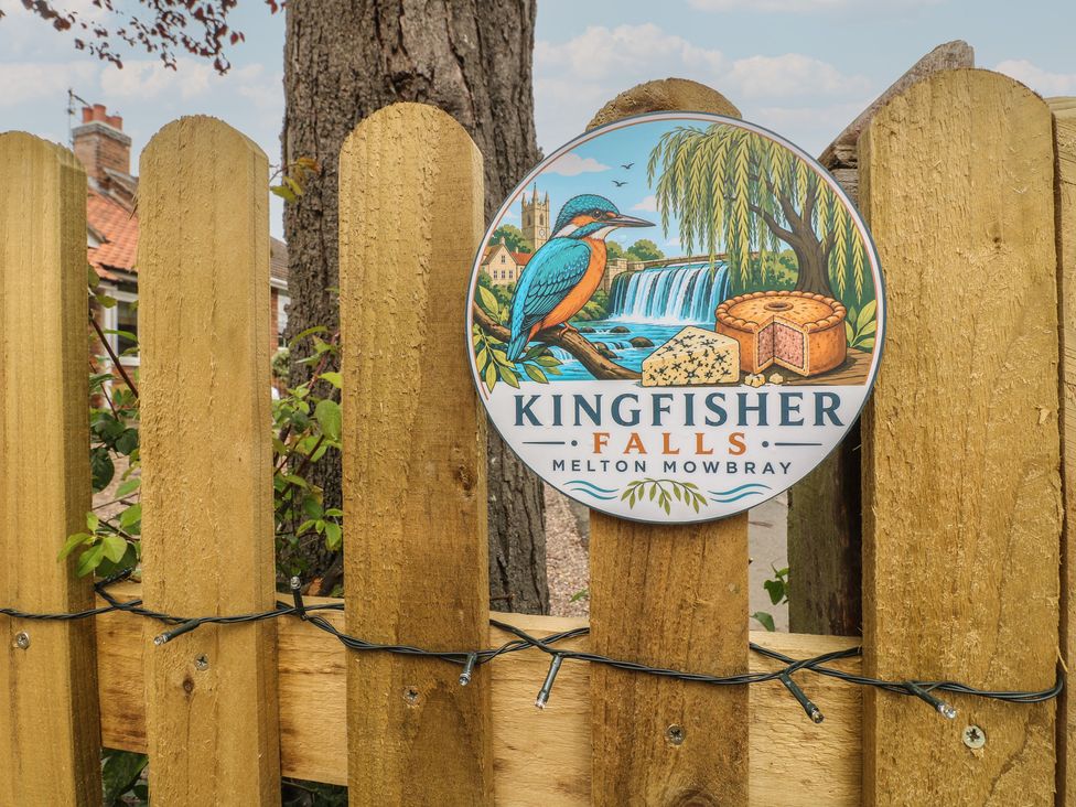 A sign on a wooden fence at Kingfisher Falls in Melton Mowbray