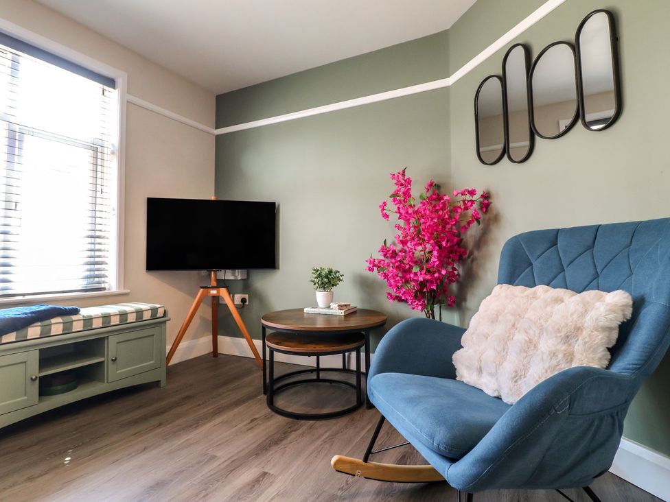 A living room with a television and a coffee table at The Kingfisher Falls in Melton Mowbray