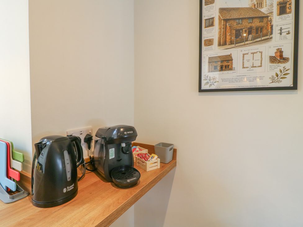 A kitchen area with a kettle and coffee maker at The Kingfisher Falls in Melton Mowbray