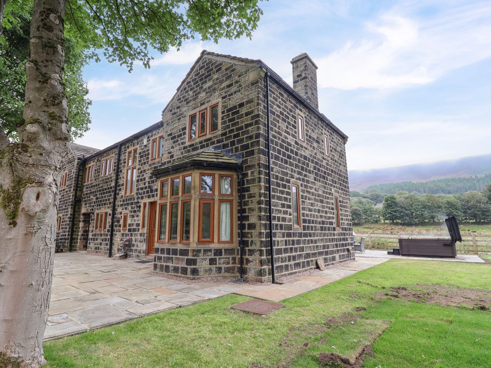 A stone house with windows and patio near Greenfield Manor near Greenfield