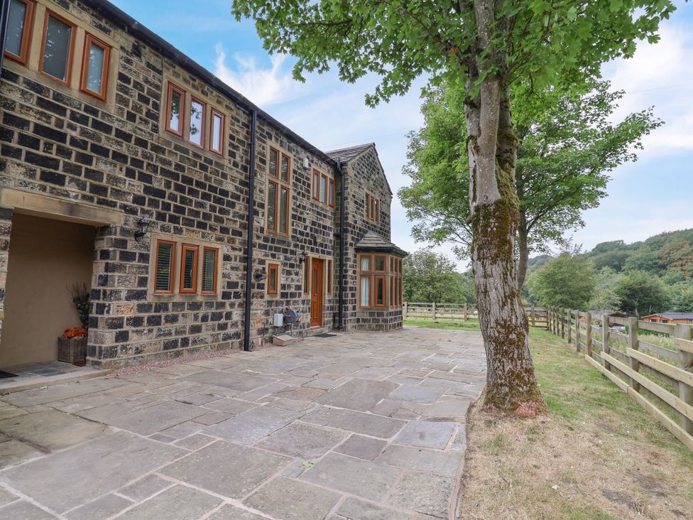 An outdoor area with a stone house and trees at Greenfield Manor near Greenfield