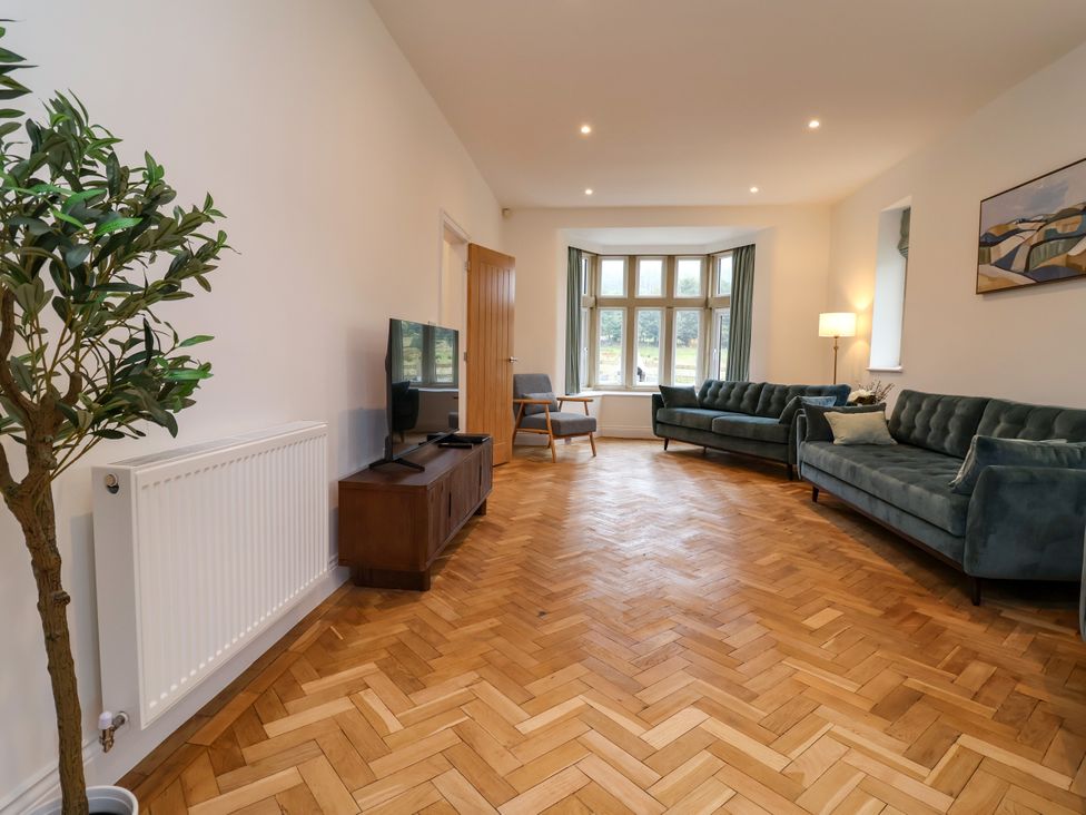 A living room with sofas and a television at Greenfield Manor near Greenfield
