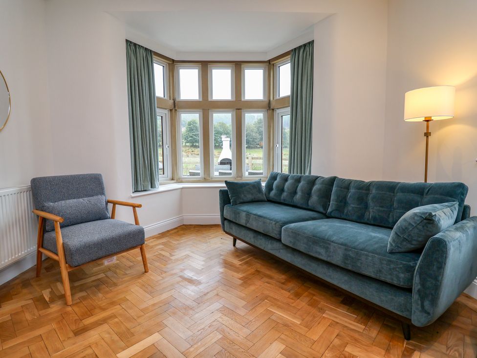 A living room with a sofa and armchair at Greenfield Manor near Greenfield