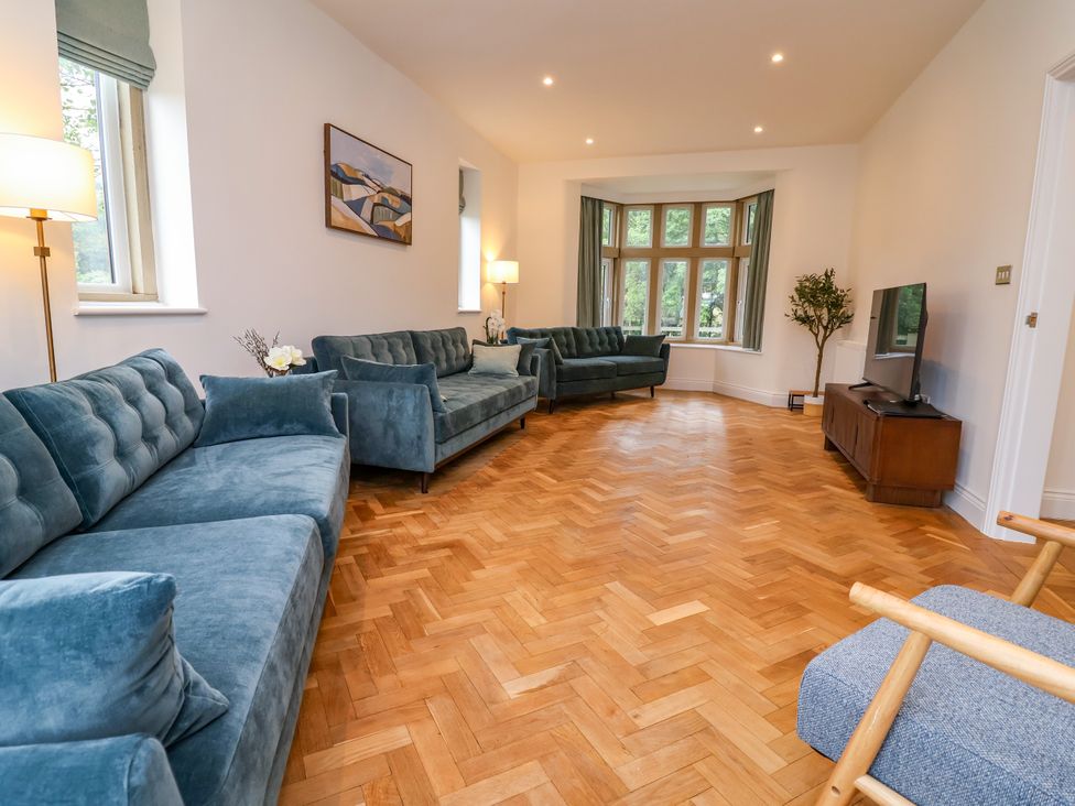 A living room with sofas and a television at Greenfield Manor near Greenfield