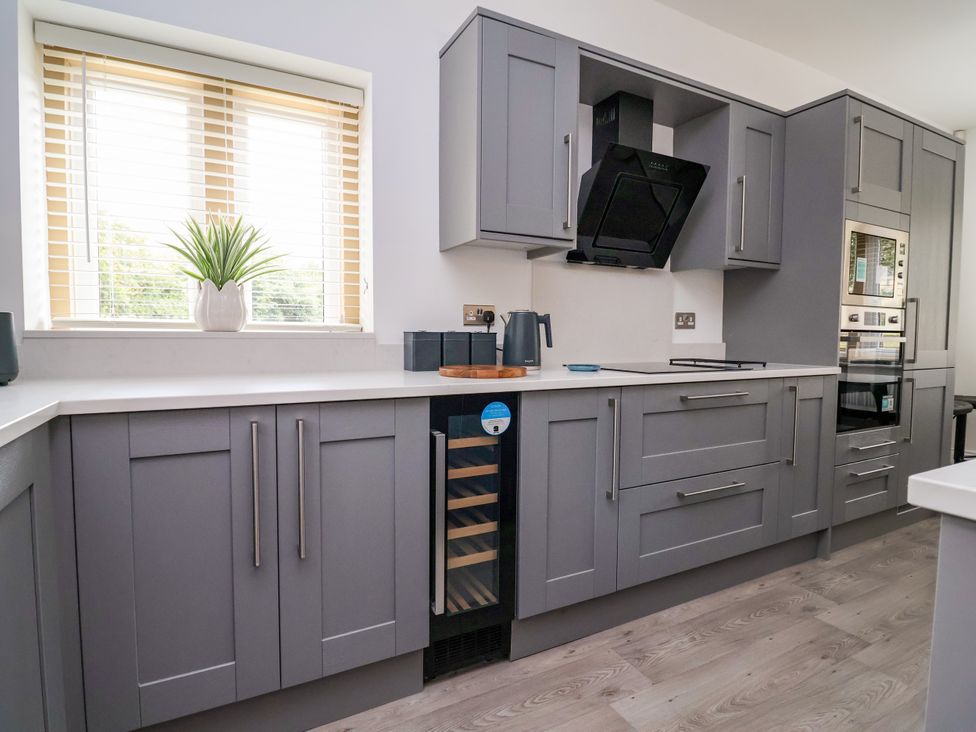 A kitchen with grey cabinets and a countertop at Greenfield Manor near Greenfield