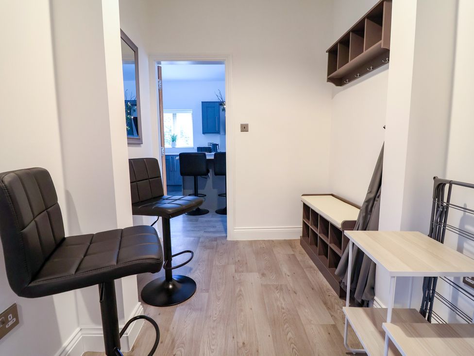 A hallway with bar stools and a shelving unit at Greenfield Manor near Greenfield