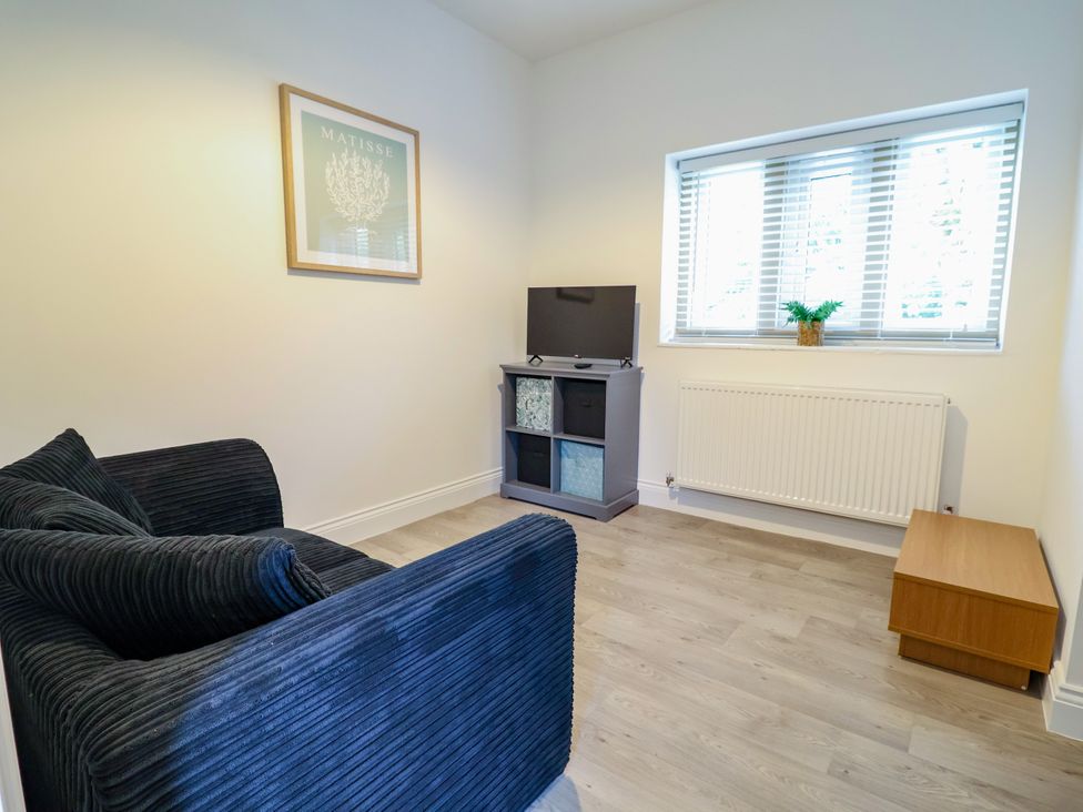 A living room with a sofa and a television at Greenfield Manor near Greenfield