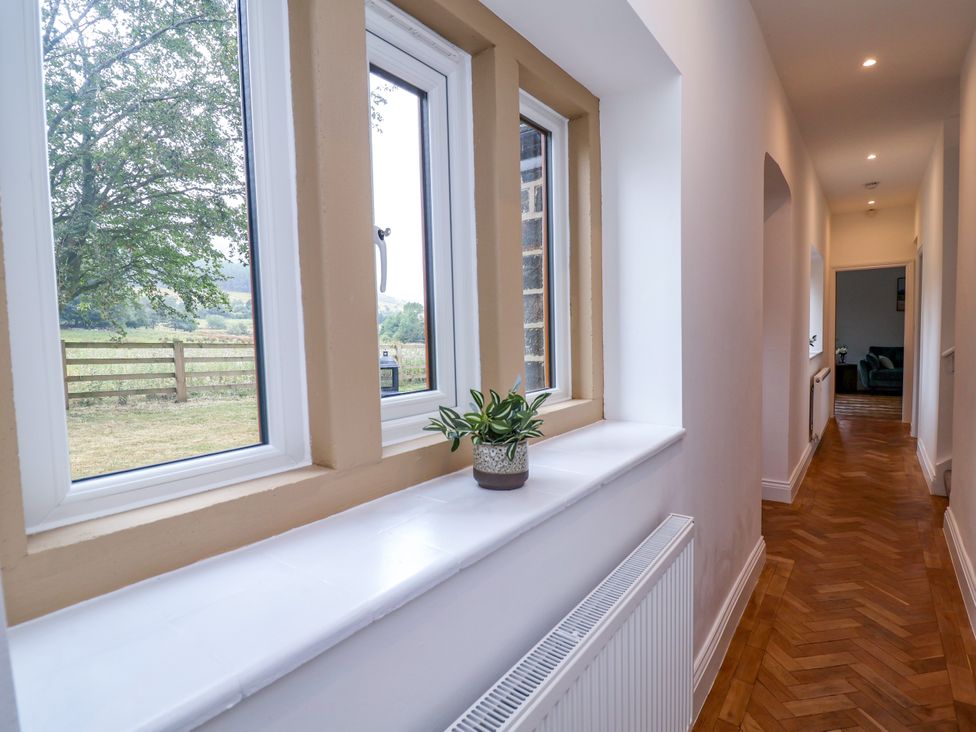 A hallway with windows and plant at Greenfield Manor near Greenfield