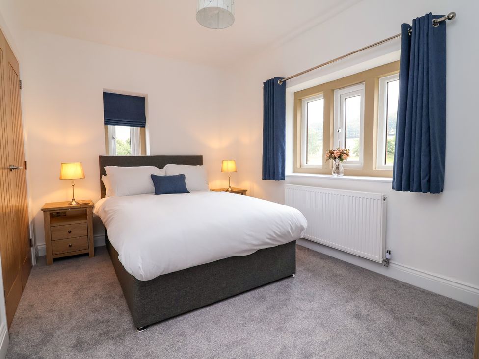 A bedroom with a bed and nightstand at Greenfield Manor near Greenfield