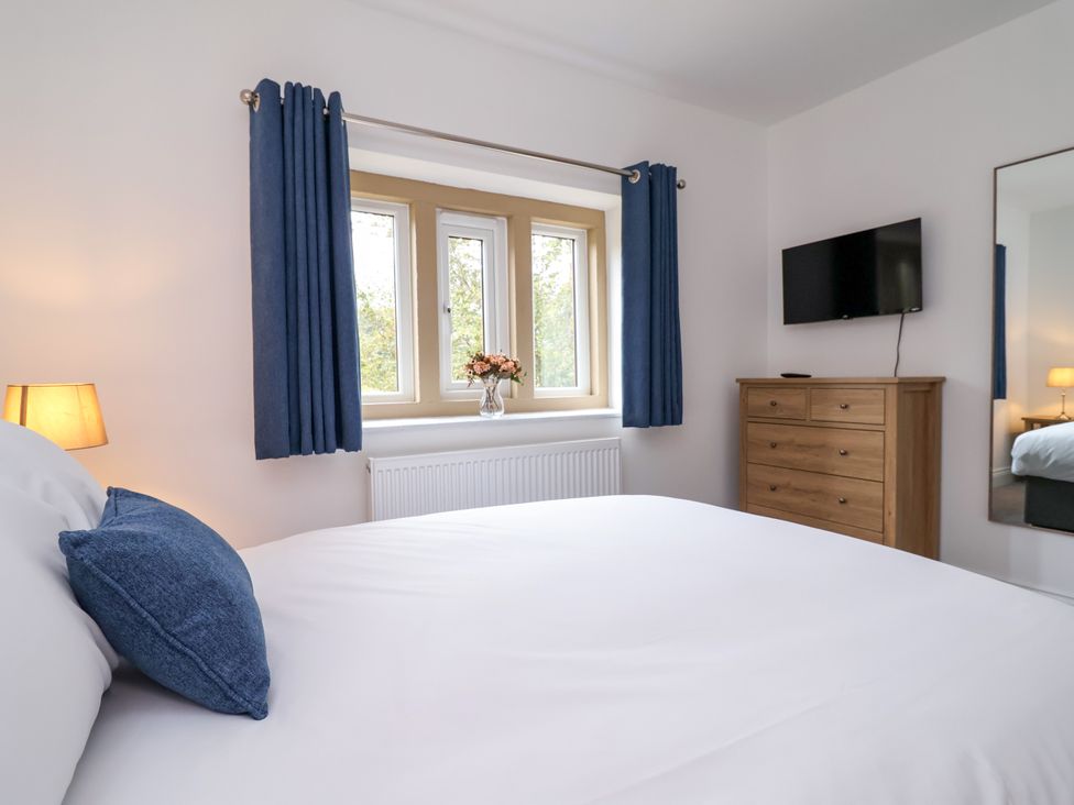 A bedroom with a bed and television at Greenfield Manor near Greenfield