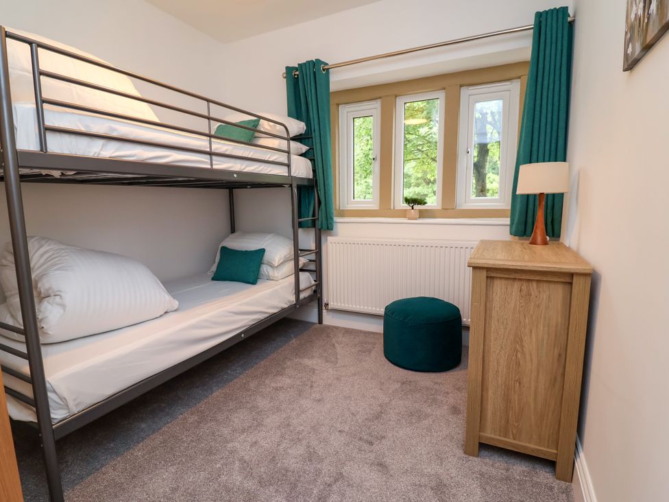 A bedroom with bunk beds and a lamp at Greenfield Manor near Greenfield