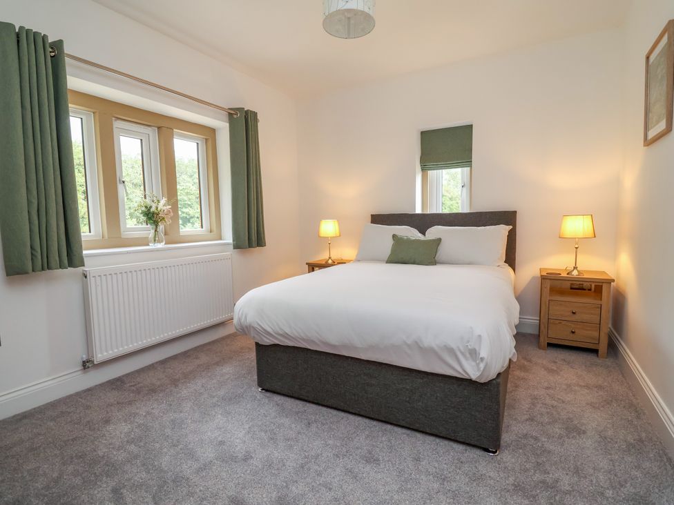 A bedroom with a bed and a bedside table at Greenfield Manor near Greenfield