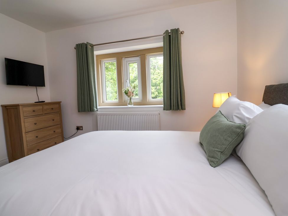 A bedroom with a bed and television at Greenfield Manor near Greenfield