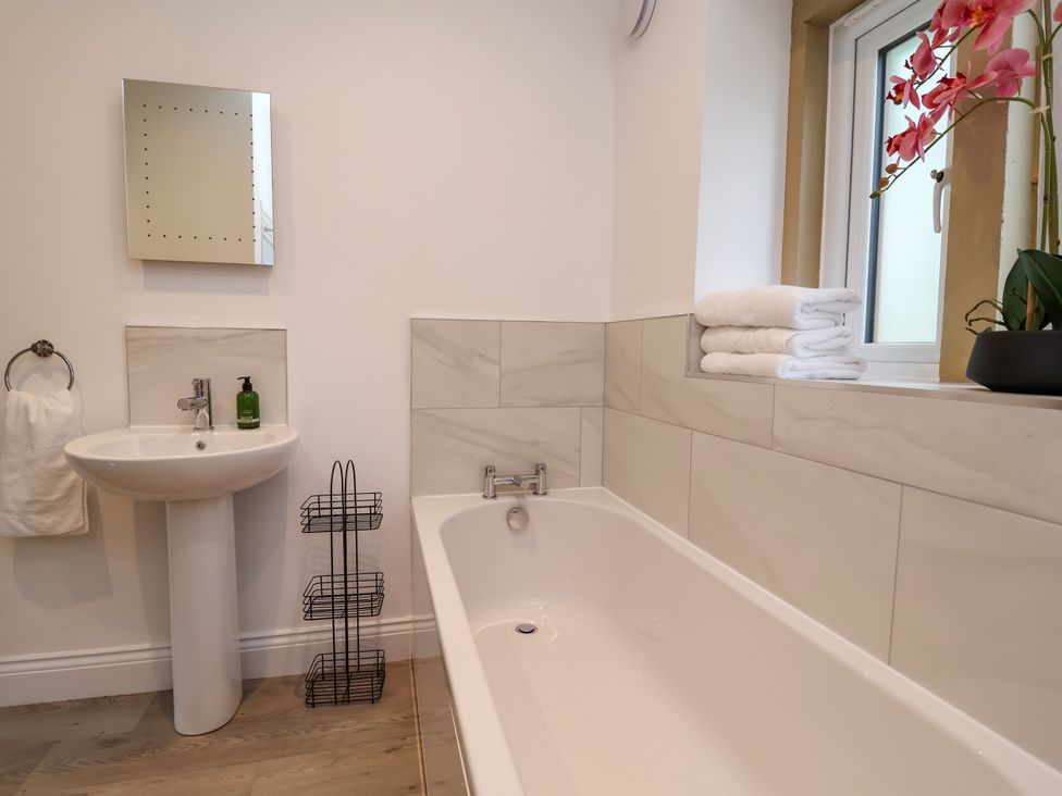 A bathroom with a sink and bathtub at Greenfield Manor near Greenfield