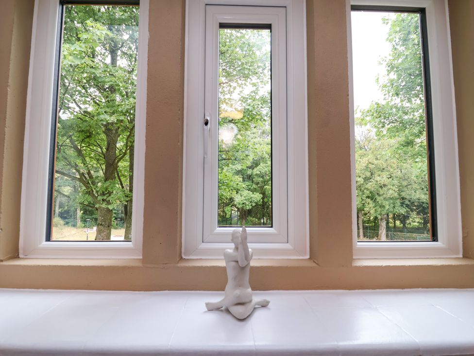 A sculpture on a window sill with trees visible outside at Greenfield Manor near Greenfield