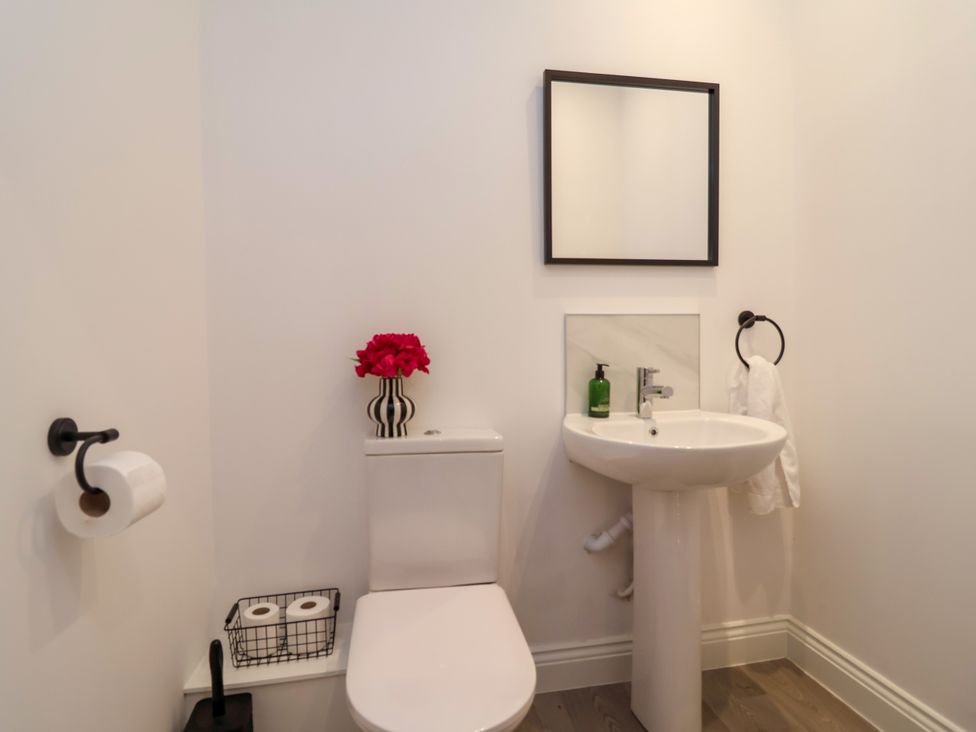 A bathroom with a toilet and sink at Greenfield Manor near Greenfield