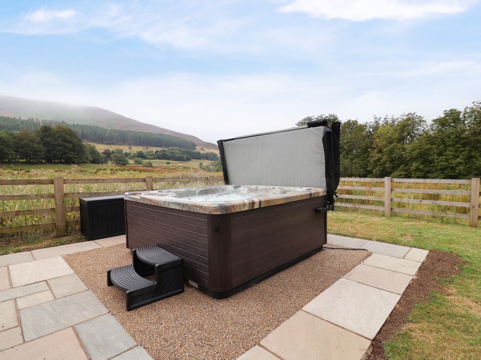 A hot tub with steps on a patio at Greenfield Manor near Greenfield