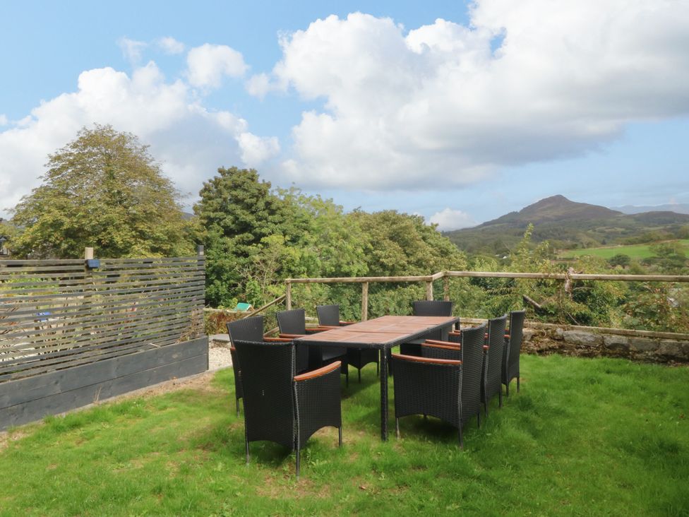 A table with chairs in a garden at Ty Mawr in Criccieth