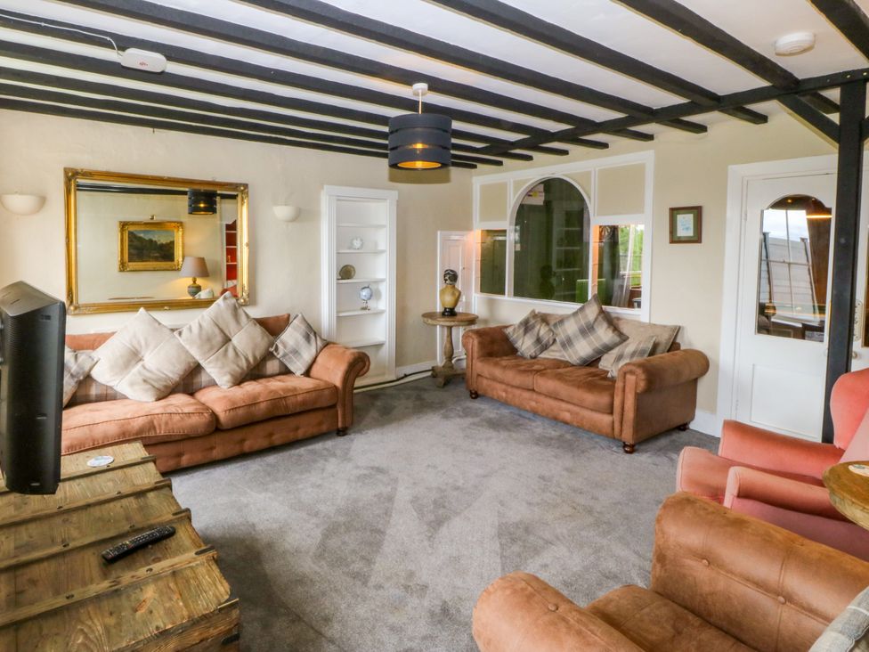 A living room with sofas and a coffee table at Ty Mawr in Criccieth