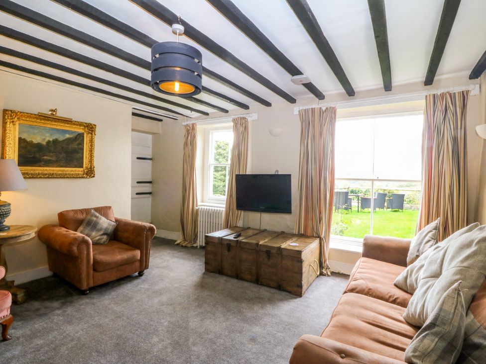 A living room with a sofa and television at Ty Mawr in Criccieth