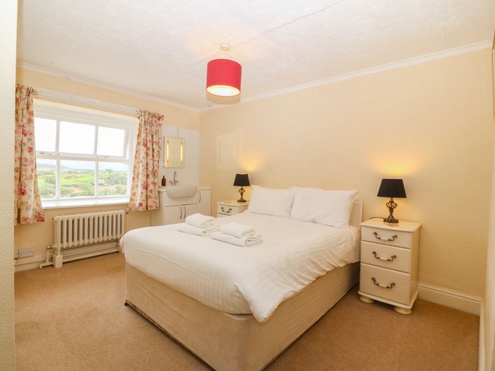 A bedroom with a bed and side tables at Ty Mawr in Criccieth